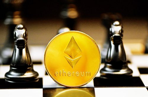 ethereum gold coin and a chess set black pieces behind it
